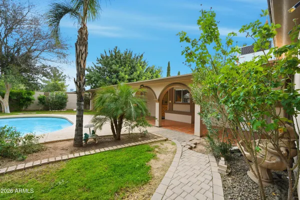 a view of a house with swimming pool and sitting area