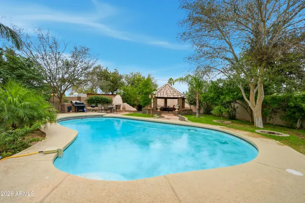 a view of a house with swimming pool and sitting area