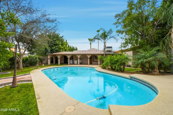 a swimming pool with outdoor seating and yard