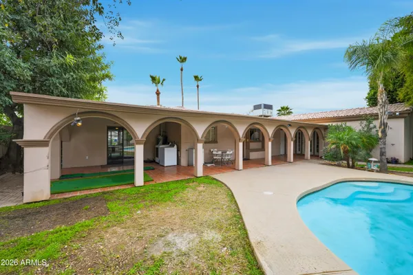 a view of backyard with sitting area