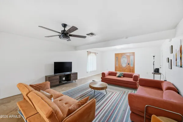 a open kitchen with granite countertop a stove a sink a dining table and chairs