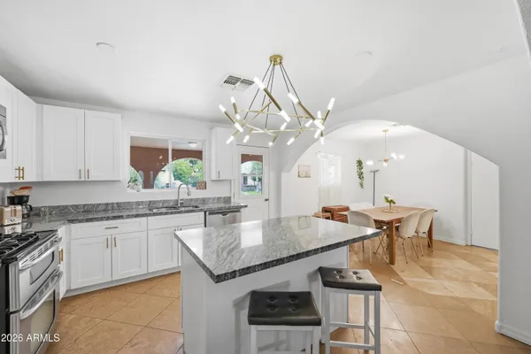 a kitchen with a sink stove and cabinets