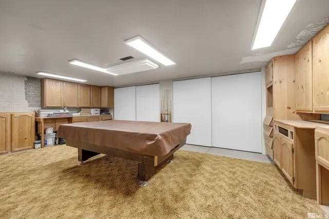 a spacious bedroom with a bed a table and chairs