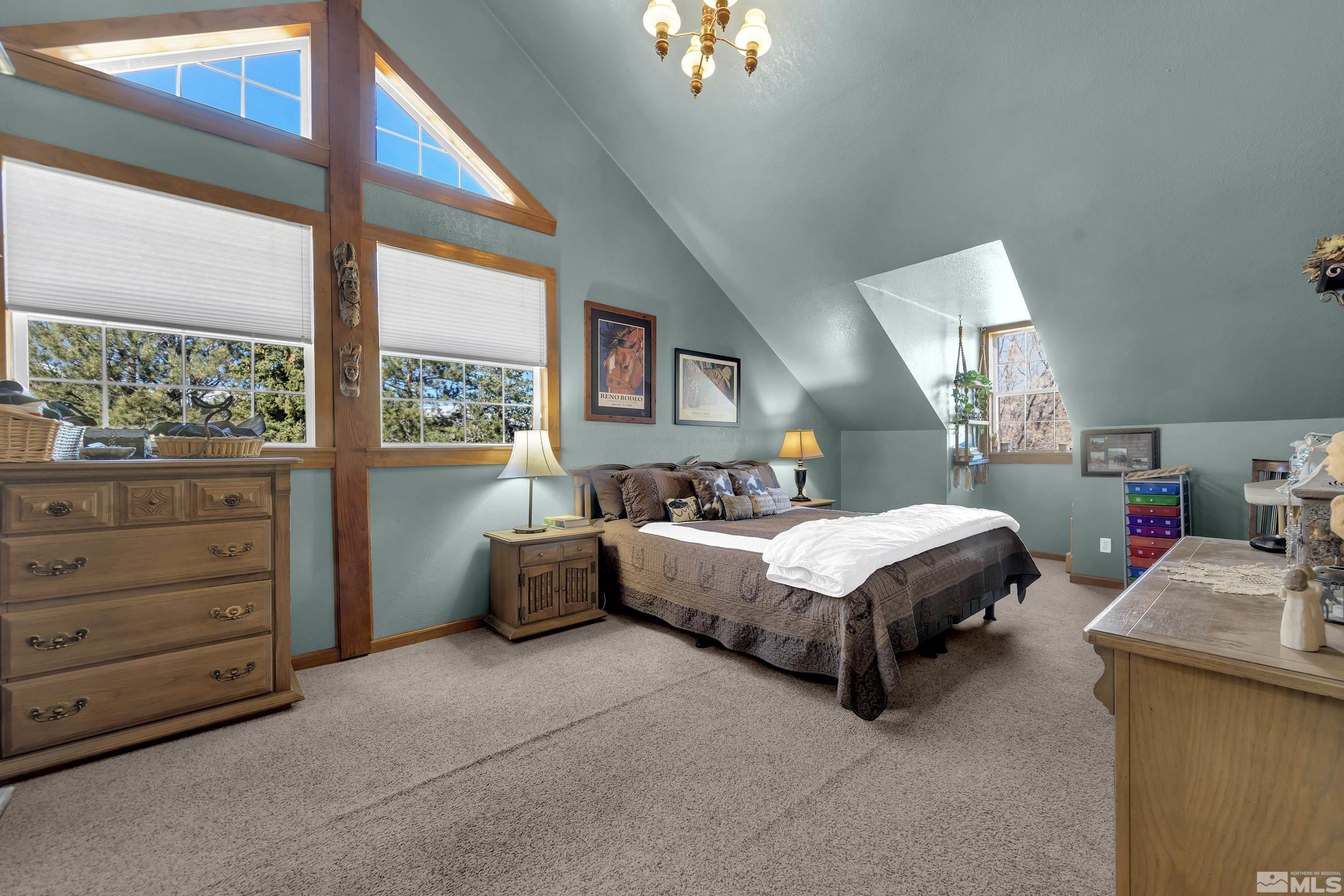 3380 Mario Road Reno, NV 89523 - Photo 19 of 40 a spacious bedroom with a bed and a large window