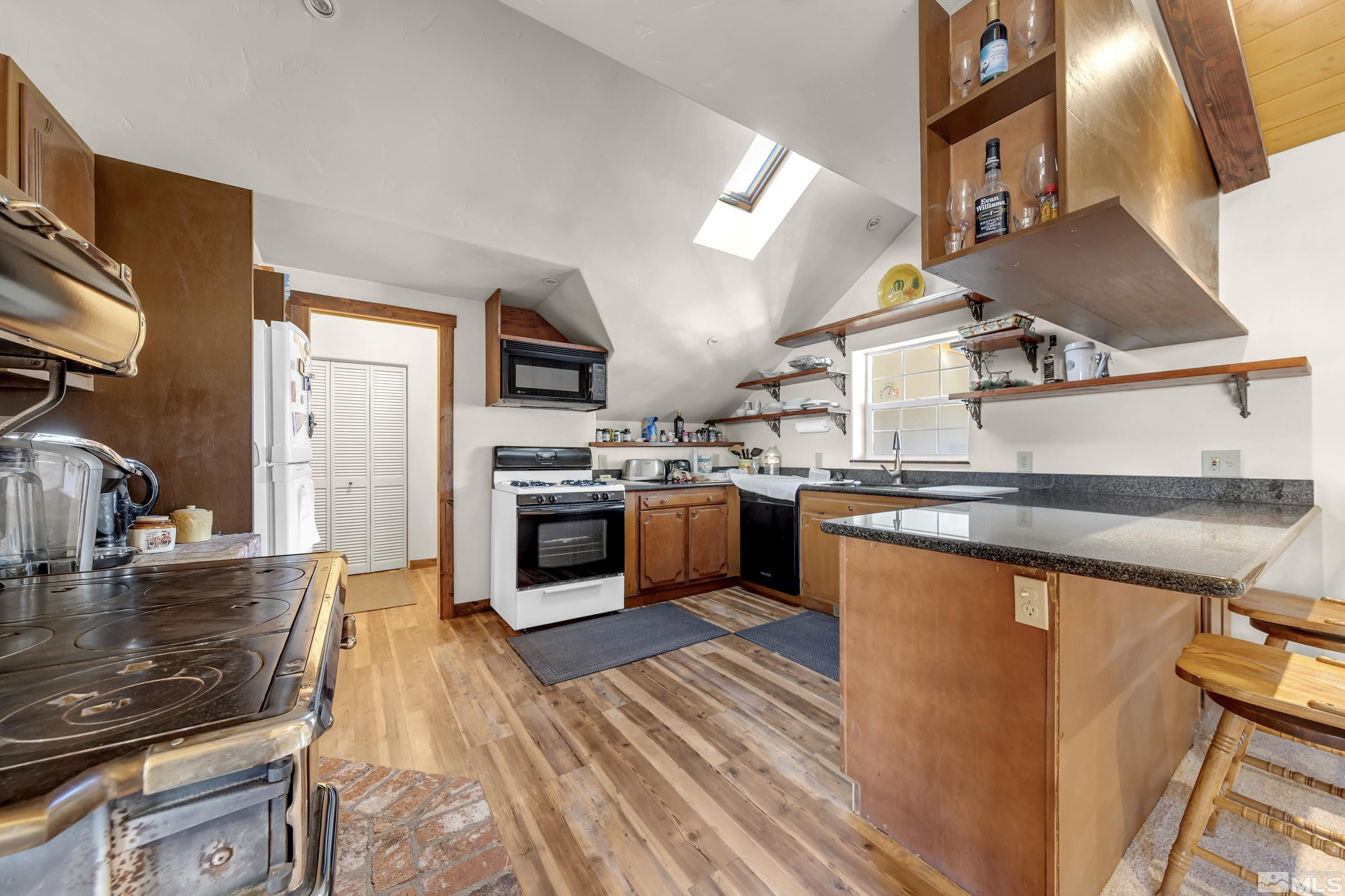 3380 Mario Road Reno, NV 89523 - Photo 33 of 40 a kitchen with stainless steel appliances granite countertop a sink a stove and a refrigerator