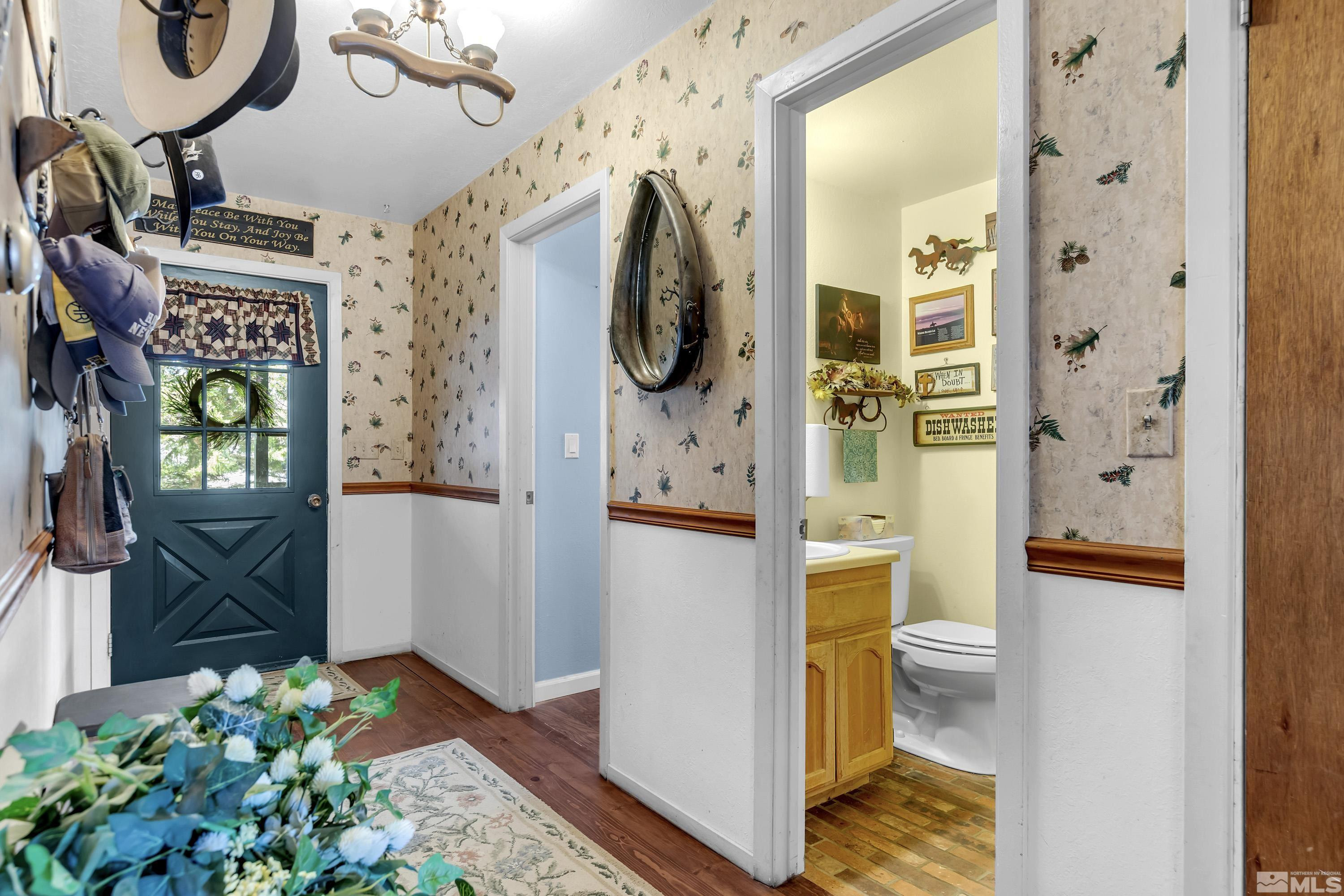 3380 Mario Road Reno, NV 89523 - Photo 4 of 40 a hallway with painting on the wall and a potted plant