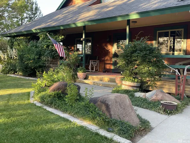 a view of a house with swimming pool and garden