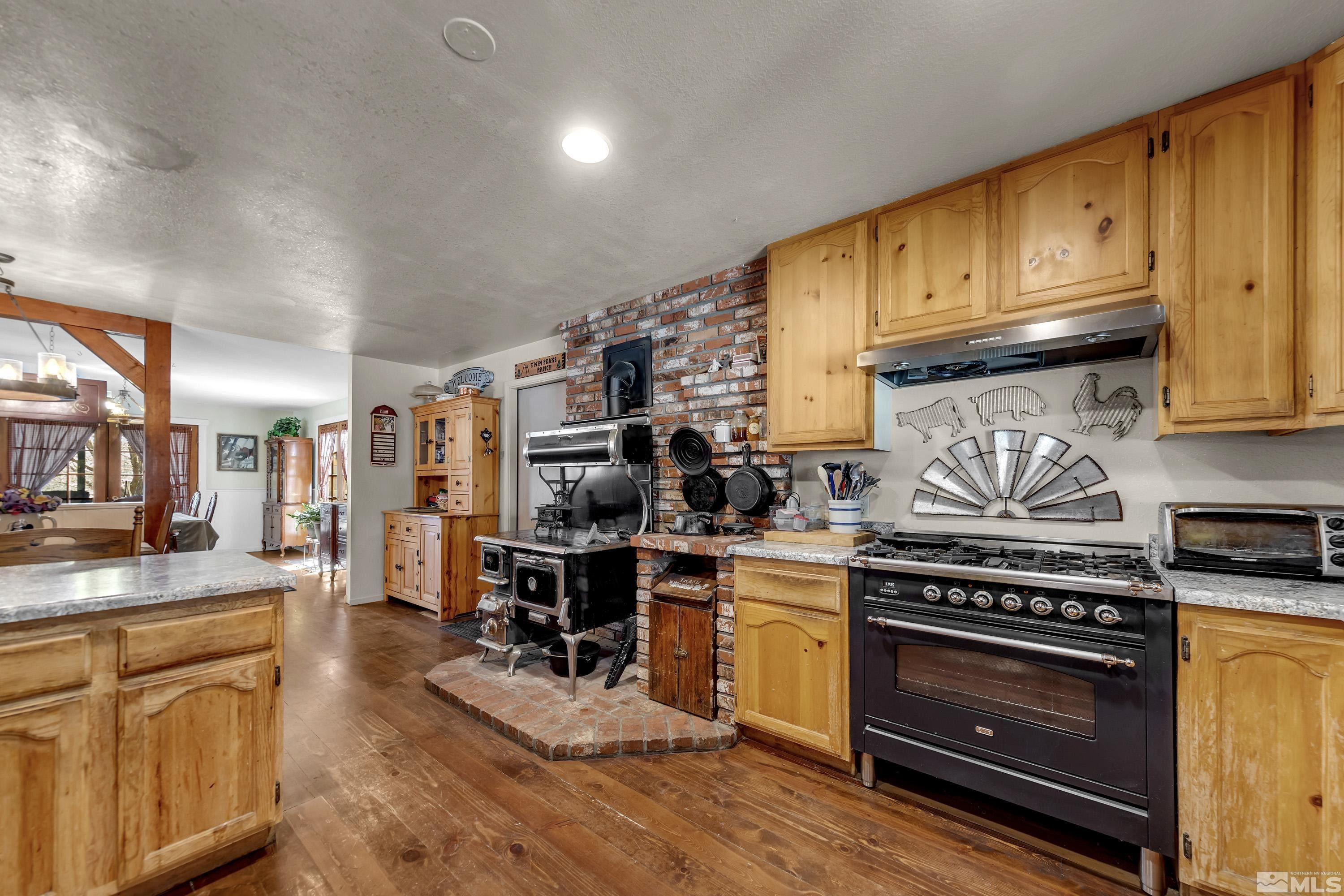 3380 Mario Road Reno, NV 89523 - Photo 6 of 40 a kitchen with stainless steel appliances granite countertop a stove and cabinets