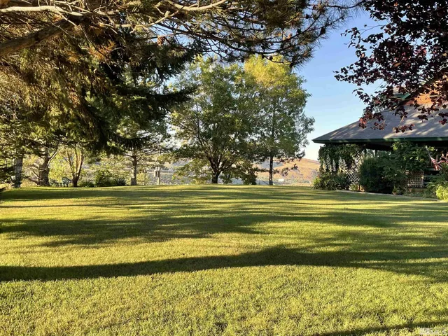 a view of swimming pool with outdoor seating and yard