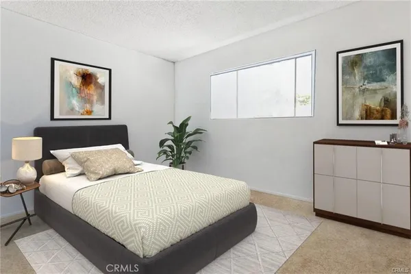 a bedroom with a large bed and a painting on the wall
