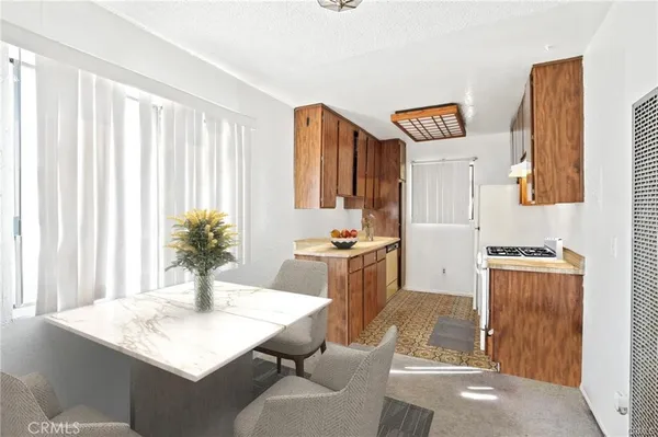 a living room with stainless steel appliances kitchen island granite countertop furniture and a kitchen view