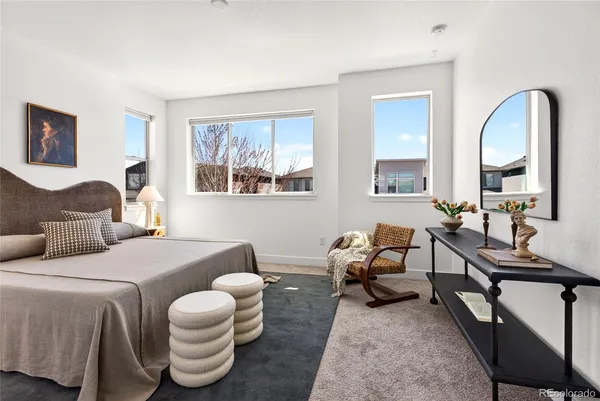a spacious bedroom with two beds and a large mirror next to a window