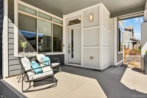 a living room with furniture a large window and glass door