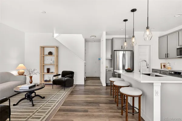 a living room with furniture a mirror and a chandelier