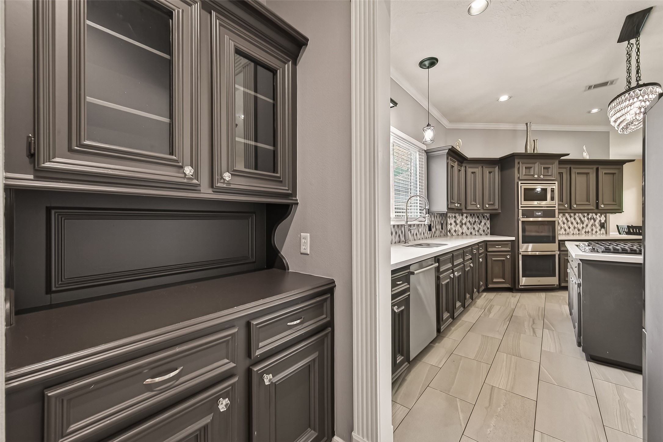 17107 Wunder Hill Drive Spring, TX 77379 - Photo 13 of 48 Butler's pantry connects the kitchen and dining and offers access to the laundry and pantry.