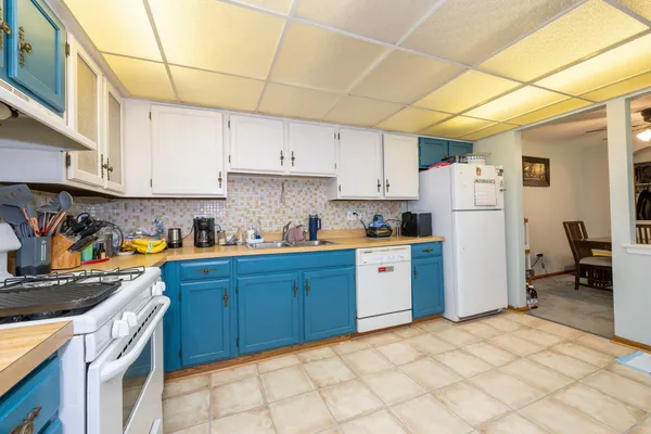 a kitchen with a refrigerator sink and cabinets