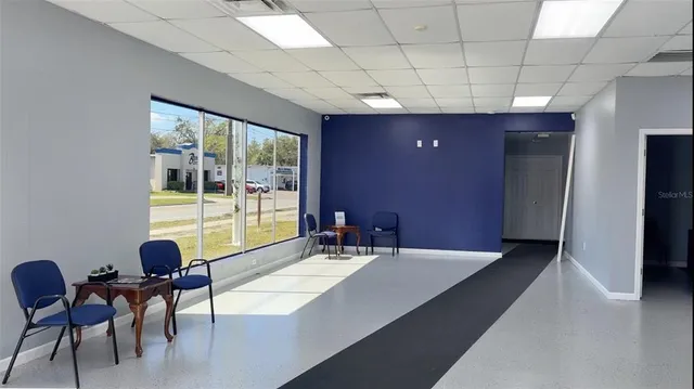 a lobby with a couch and a potted plant