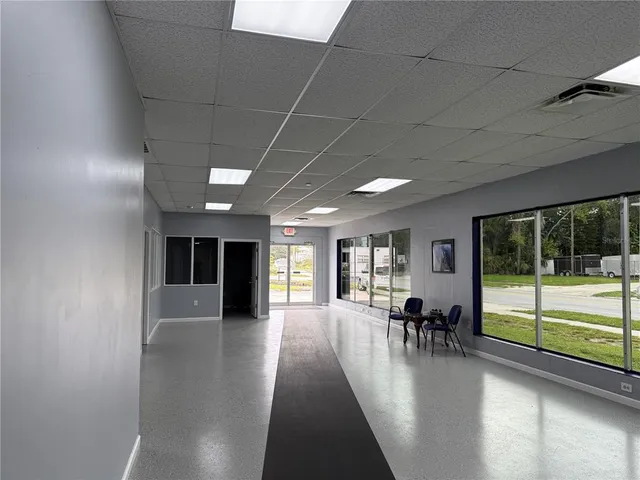 a lobby with furniture and floor to ceiling window