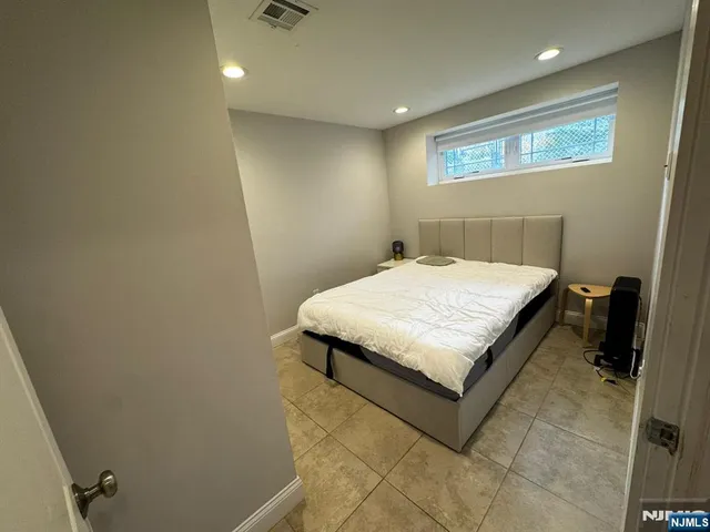 a bedroom with a bed and a wall painting