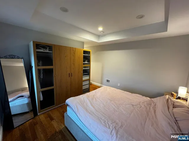 a bedroom with a bed and a mirror