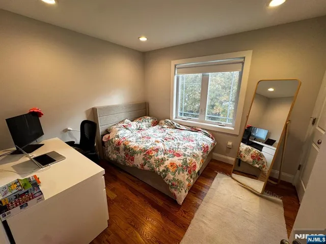 a bedroom with two beds and a window