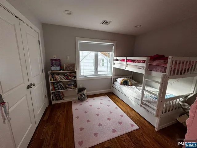 a bedroom with furniture and a book shelf