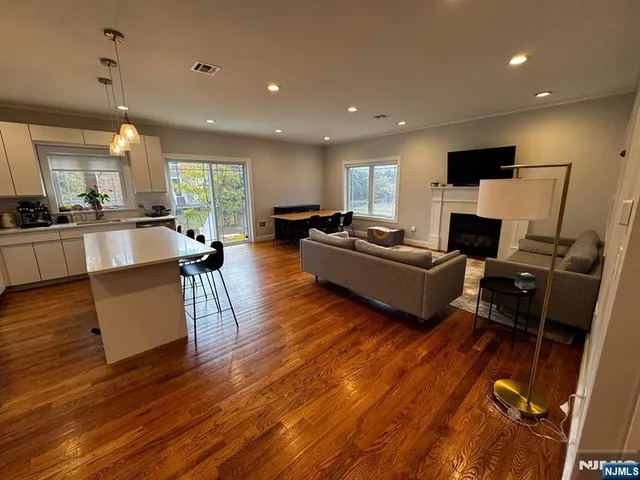 a living room with fireplace furniture and a wooden floor