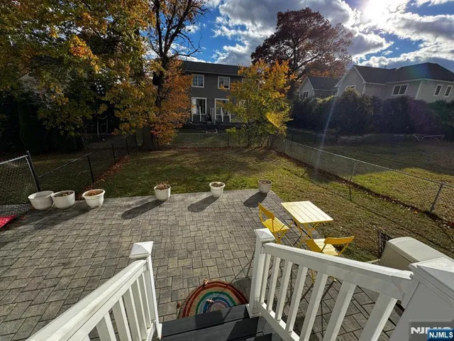 a view of a balcony with two chairs and a fire pit