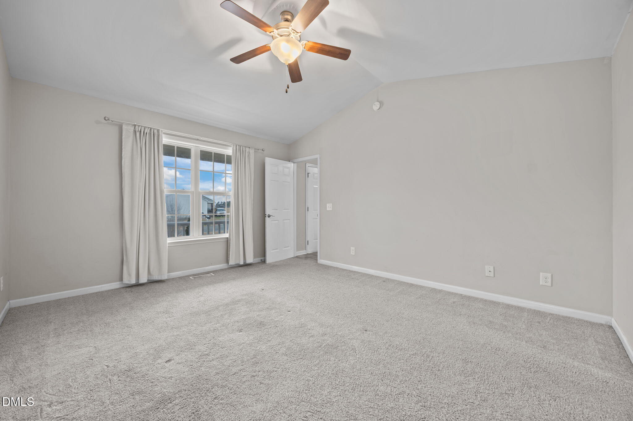 24 Sue Drive Angier, NC 27501 - Photo 10 of 39 an empty room with windows and fan