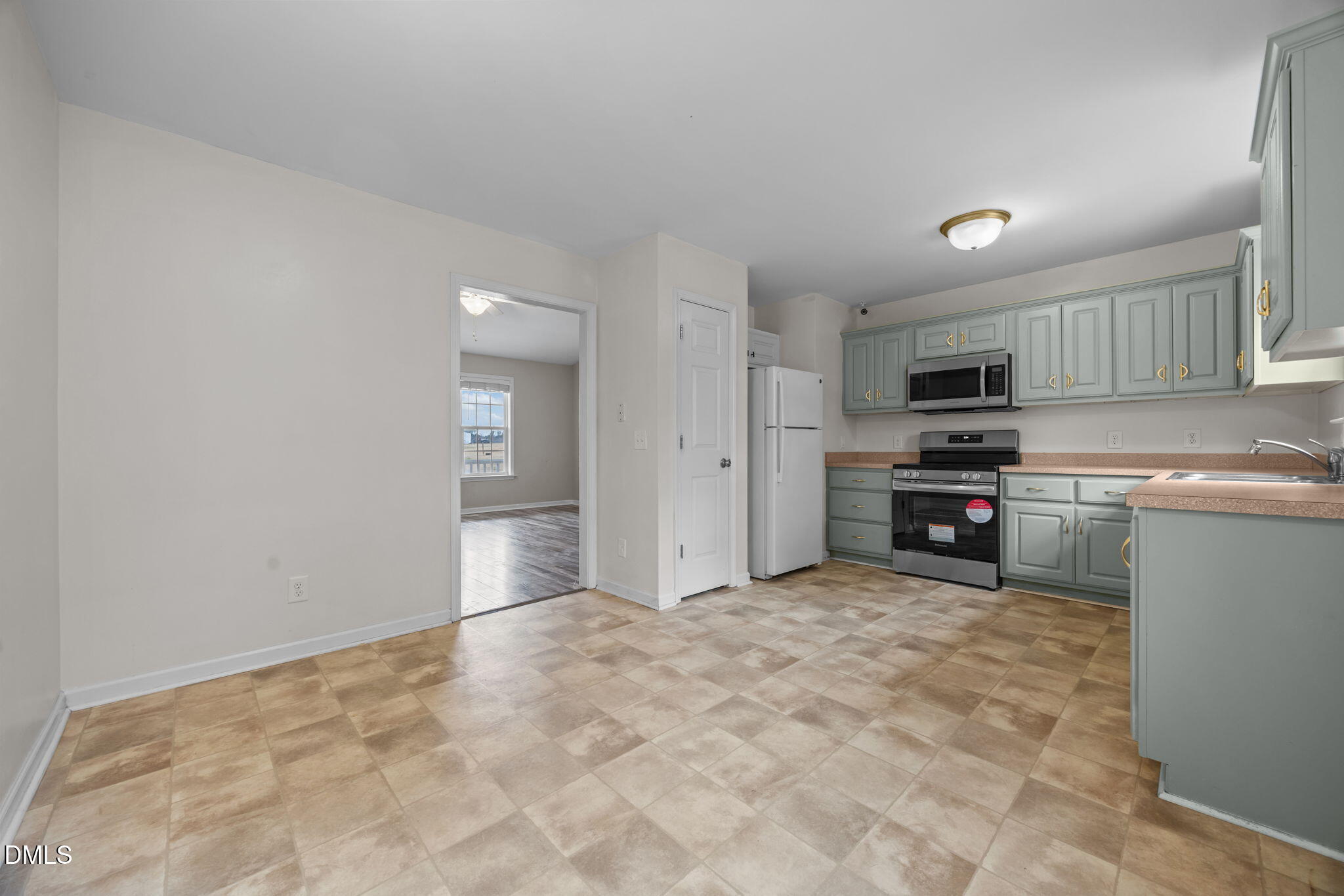 24 Sue Drive Angier, NC 27501 - Photo 27 of 39 a view of a kitchen with a sink and dishwasher a stove top oven with wooden floor