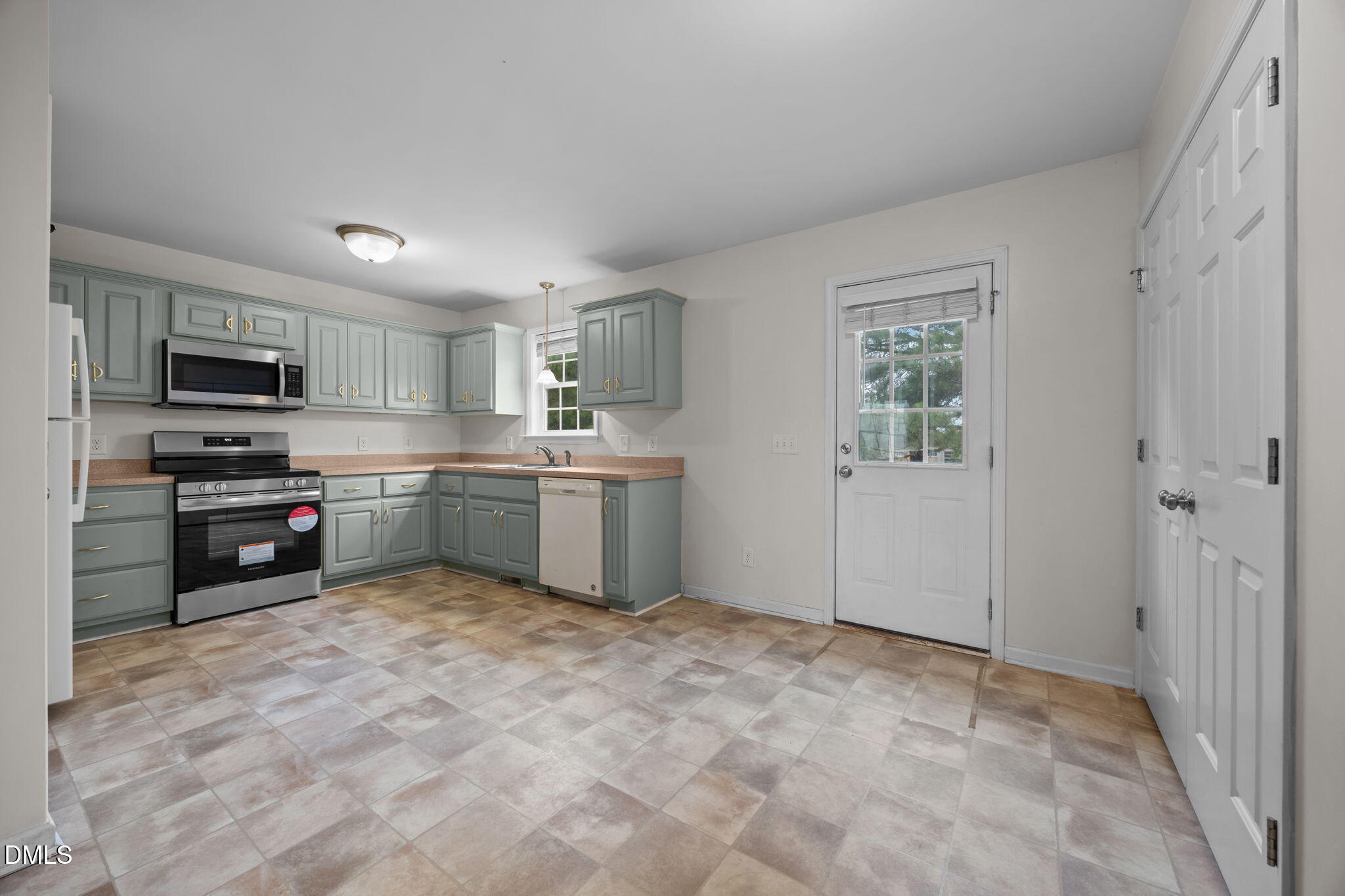 24 Sue Drive Angier, NC 27501 - Photo 30 of 39 a kitchen with stainless steel appliances a sink and cabinets