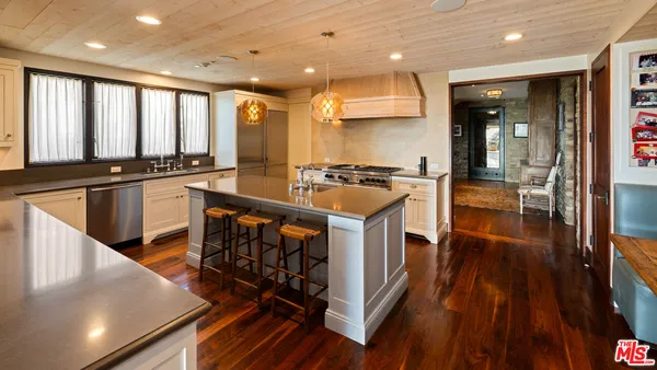 a open kitchen with stainless steel appliances granite countertop a stove and cabinets