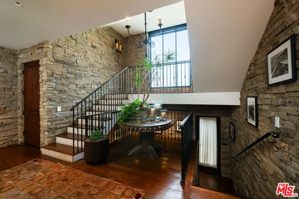 a spacious bedroom with a bed a couch and a fireplace