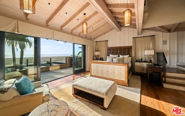 a kitchen with a table chairs and a wooden floor