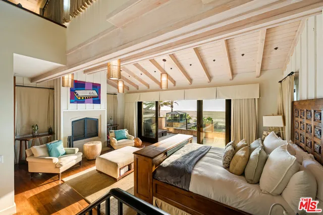 a living room with furniture and large windows