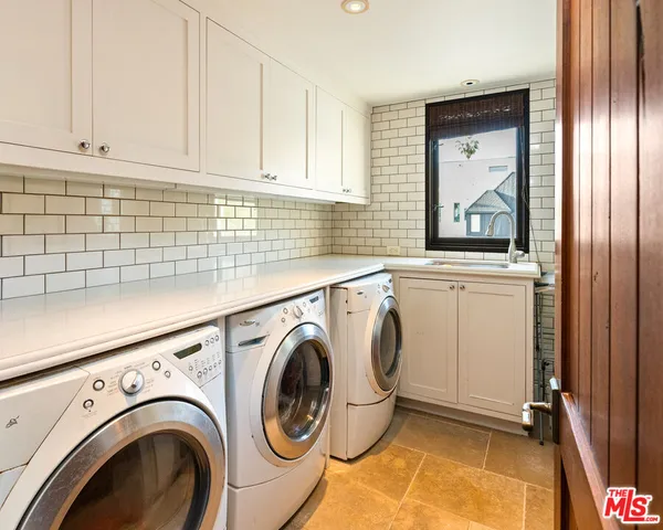 a living room with furniture a projector and a flat screen tv