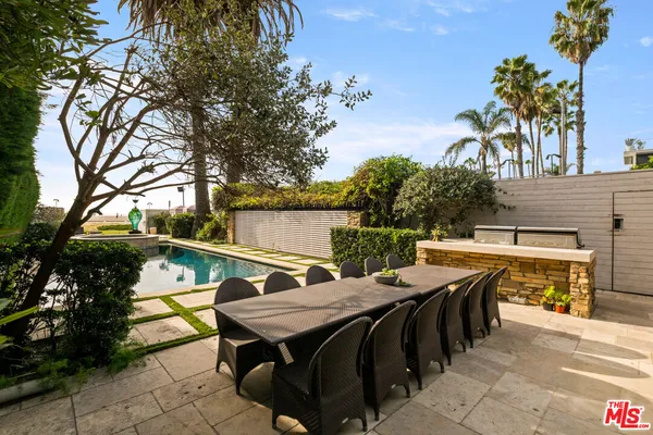 a view of a patio with table and chairs with wooden floor and fence