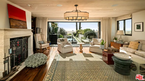 a living room with furniture large window and flat screen tv