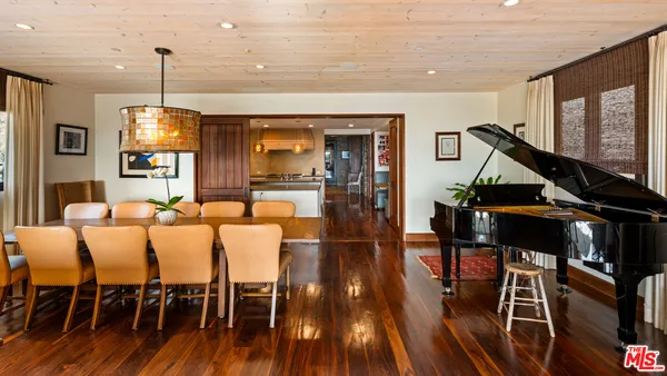 a living room with furniture a wooden floor and next to a window