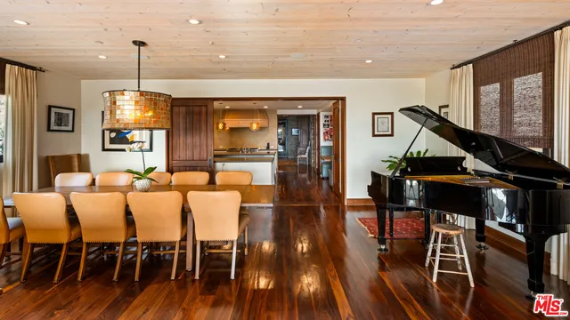 a living room with furniture a wooden floor and next to a window
