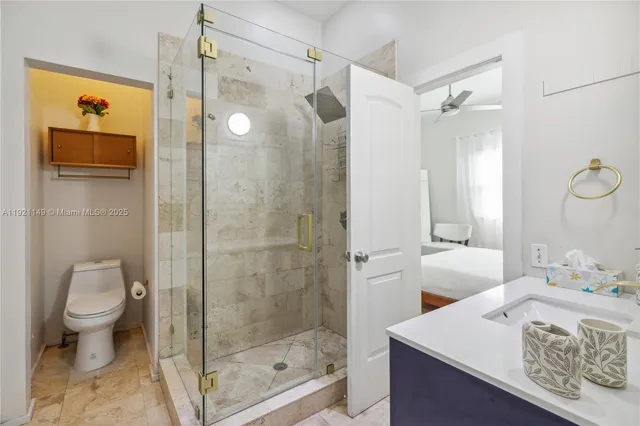 a bathroom with a sink toilet and shower