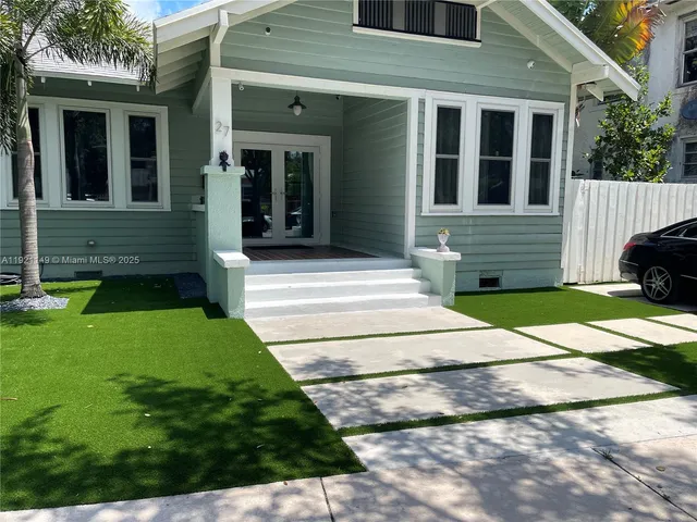 a front view of a house with garden