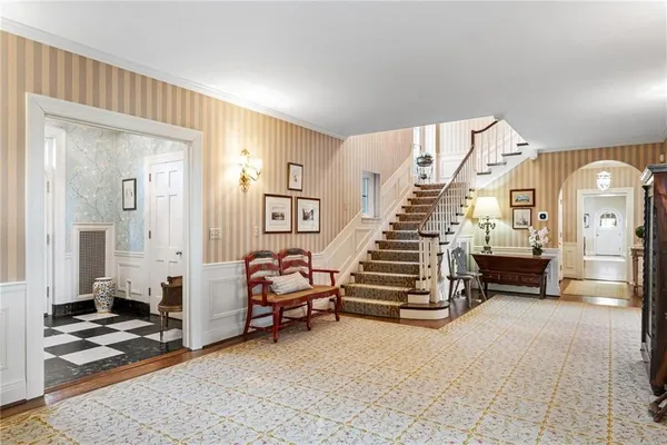 a view of a livingroom with furniture and stairs