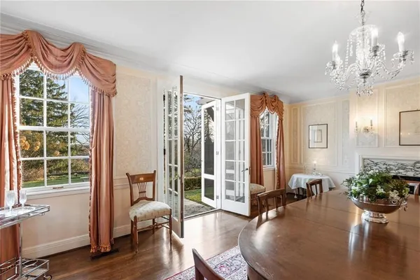 a very nice looking room with many windows and furniture