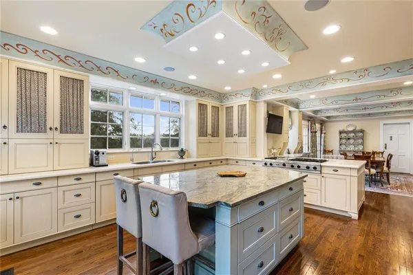 a kitchen with stainless steel appliances granite countertop a stove refrigerator and a sink