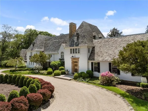 a front view of a house with a yard and outdoor seating