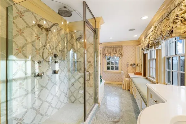 a view of a hallway with granite countertop a refrigerator and chandelier