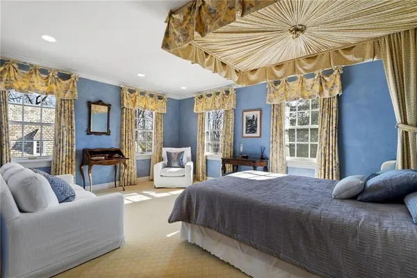 a bedroom with a large bed and a large window