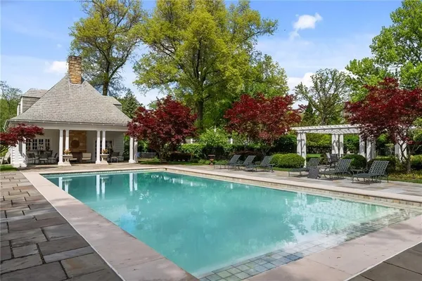 a view of a house with swimming pool and a yard