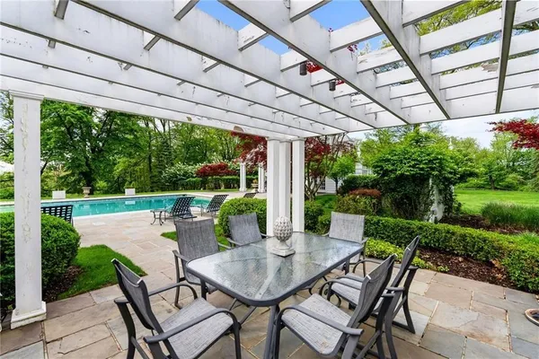 a view of a patio with a table chairs and a backyard